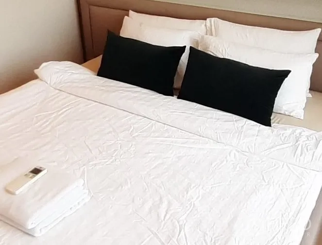 Condominium for rent in Khlong Toei, Bangkok - Third bedroom featuring king bed with white linens and black accent pillows.