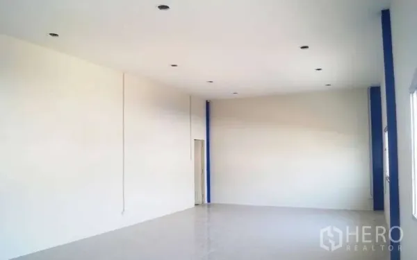 Warehouse for rent in Krathum Baen, Samut Sakhon - Clean upstairs office with white walls, tiled floor, and recessed lighting overlooking the warehouse.