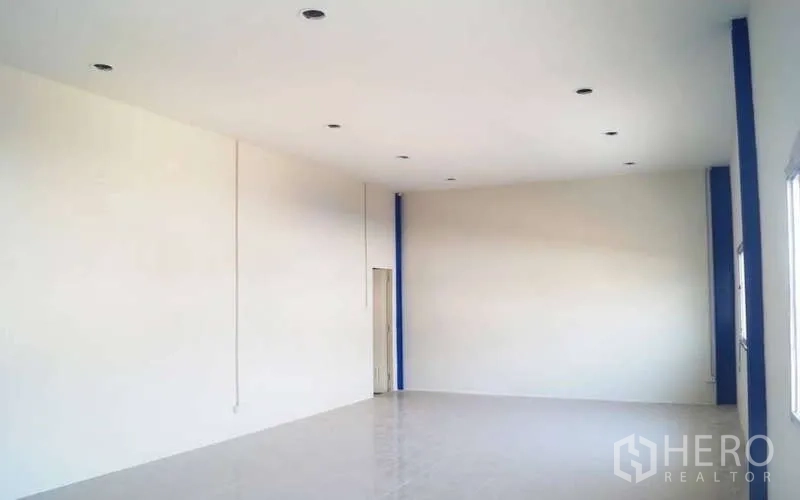 Warehouse for rent in Krathum Baen, Samut Sakhon - Clean upstairs office with white walls, tiled floor, and recessed lighting overlooking the warehouse.