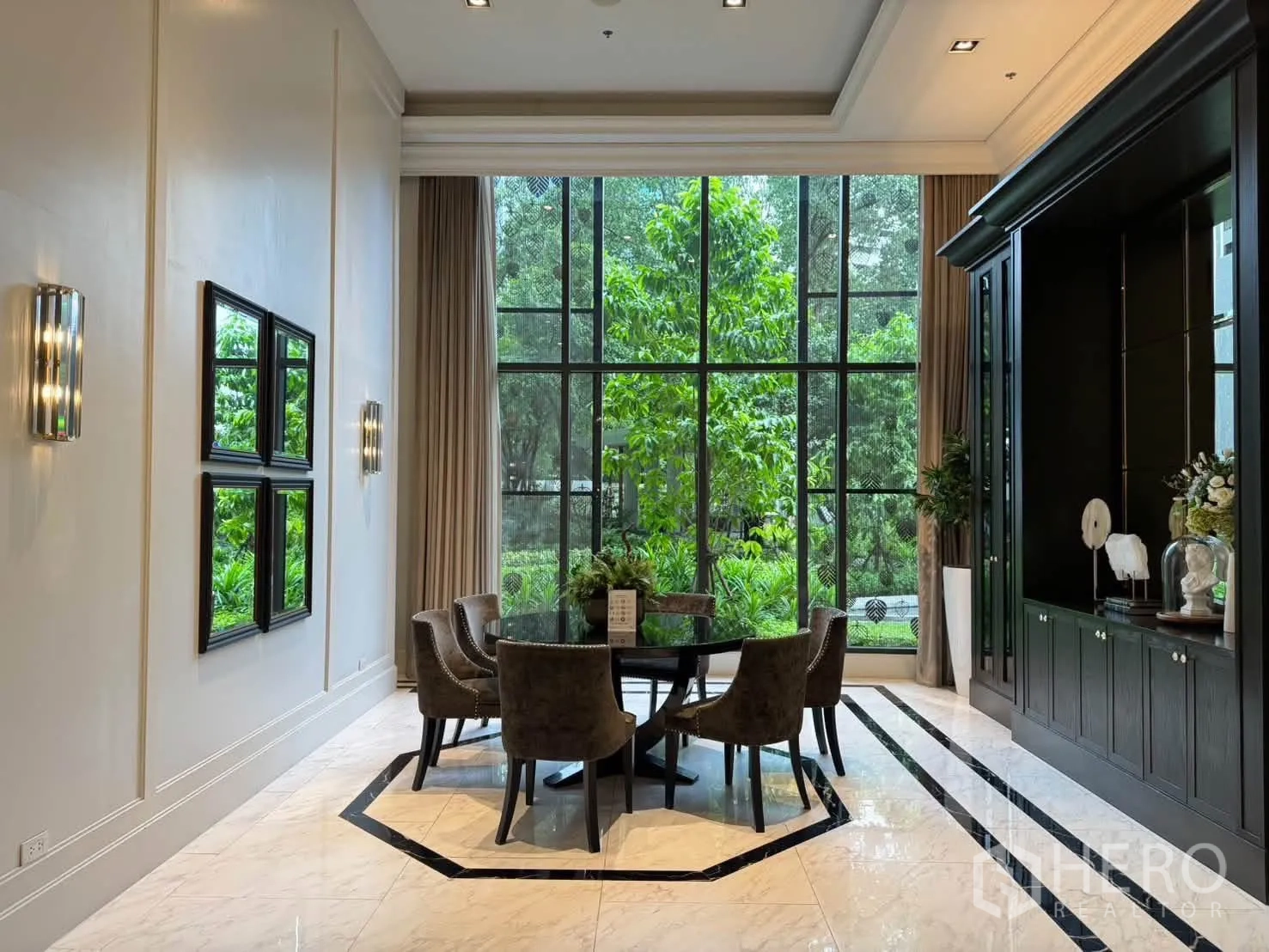 Condominium for rent in Pathum Wan, Bangkok - Private meeting room with round table, high ceiling, and greenery outside.