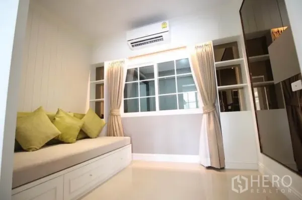 独立式住宅 出租或出售在Lat Phrao, Bangkok - 舒适多功能房，设榻榻米式沙发、书架与窗帘。