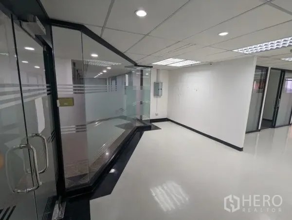 Office Space for rent or sale in Ratchathewi, Bangkok - Secure glass entry with frosted panels leading into a bright office corridor.