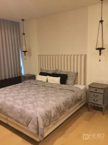 Condominium for rent in Phaya Thai, Bangkok - Serene bedroom with upholstered headboard, grey bedding, pendant lights and bedside tables.