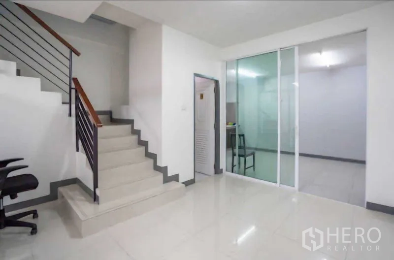 Home Office for rent or sale in Lat Krabang, Bangkok - Staircase lobby with sliding glass door opening to an additional room.