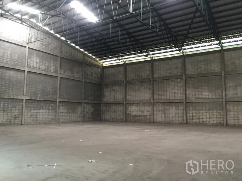 Warehouse for rent in Mueang Pathum Thani, Pathum Thani - Another view of the high-clearance warehouse interior with steel roof structure.