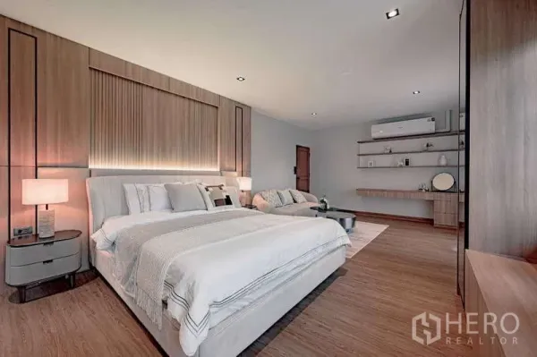 Detached House for rent or sale in Phra Khanong, Bangkok - Master bedroom angle showing upholstered bed, warm wood paneling, and shelving.