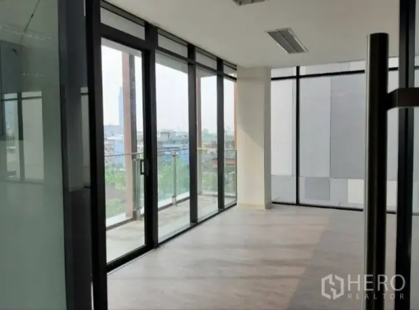 Office Space for rent in Bang Kho Laem, Bangkok - Glass-walled meeting area with sliding doors to a small balcony and city view.