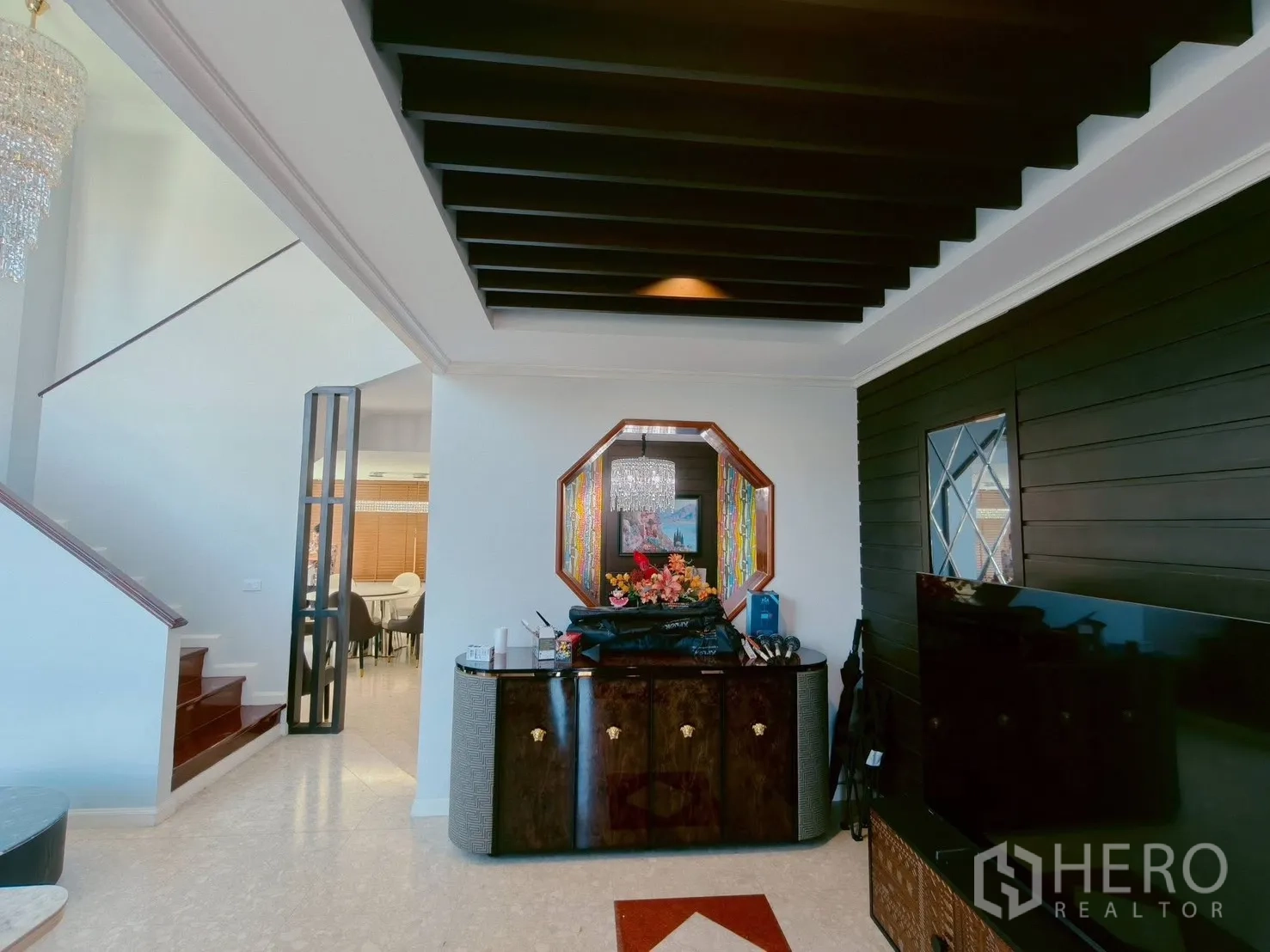 Detached House for rent in Lat Krabang, Bangkok - Open-plan living with staircase, statement mirror and beams ceiling leading to dining room.