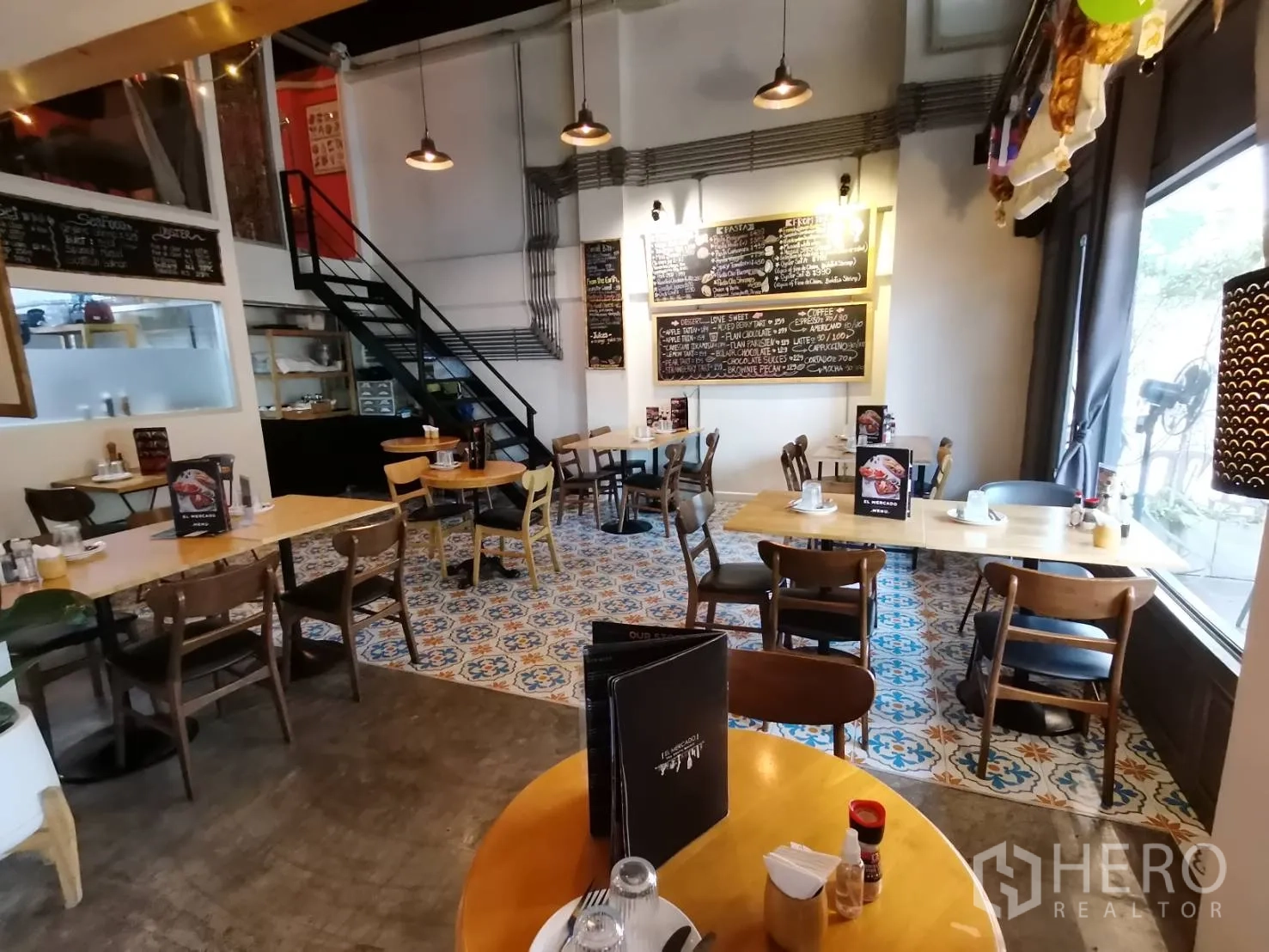 Retail Space for rent in Watthana, Bangkok - Dining room with patterned floor tiles, chalkboard menus and a steel stair.