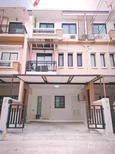 Townhouse for rent in Suan Luang, Bangkok - Three-storey townhouse facade in Suan Luang with balconies and gated covered carport