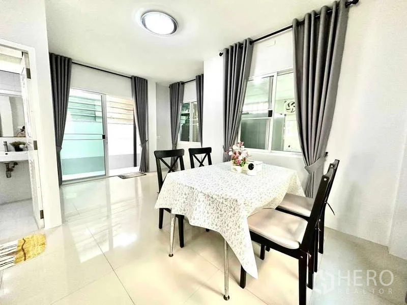 Detached House for rent in Lat Krabang, Bangkok - Bright dining corner with four-seat table and sliding glass doors.