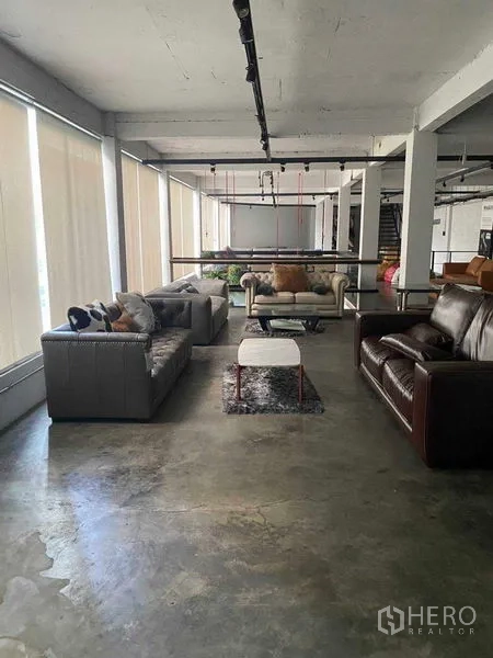 零售空间 出租在Bang Na, Bangkok - 临落地窗的明亮展区与多组沙发