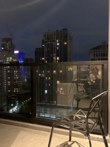Condominium for rent in Bang Rak, Bangkok - Private balcony at night with glass railing and panoramic city skyline view.