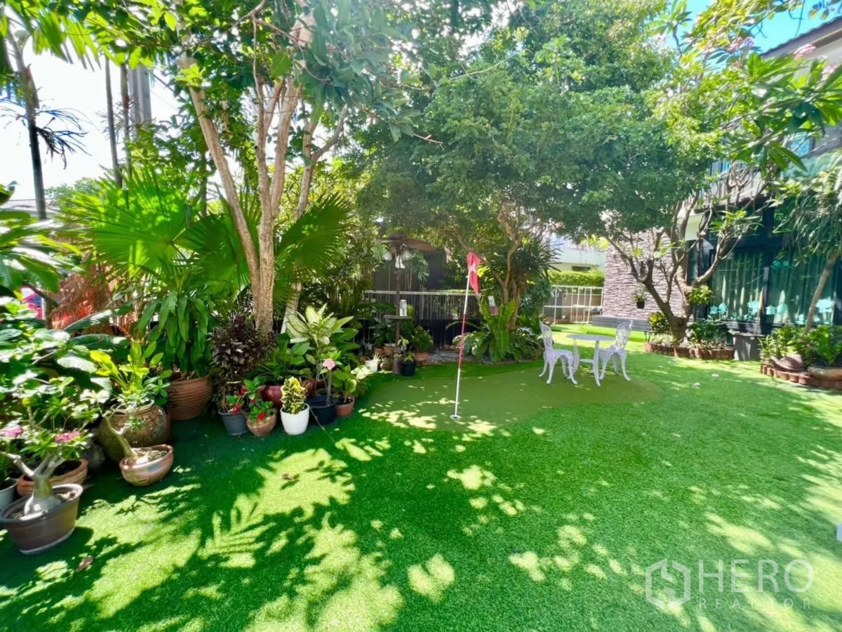 Detached House for rent or sale in Bang Kapi, Bangkok - Large landscaped garden with mature trees, potted plants and a small putting green.
