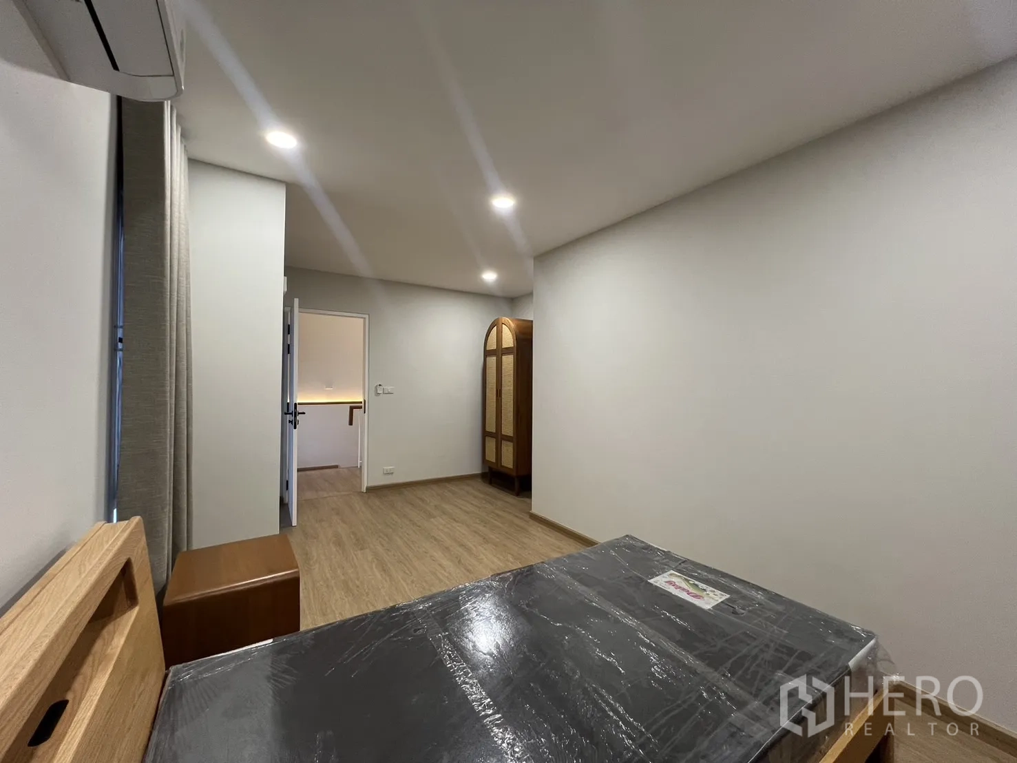 Detached House for rent in Saphan Sung, Bangkok - Third bedroom alternate angle with bed and full-length curtains.