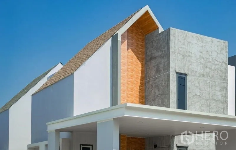 Detached House for sale in Lam Luk Ka, Pathum Thani - Angled gable roof with brick accent and concrete exterior.