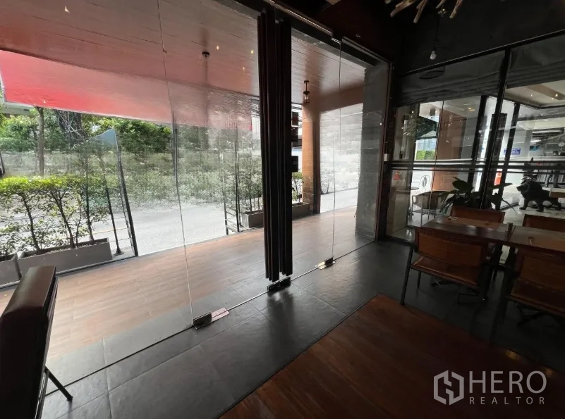 Retail Space for rent in Watthana, Bangkok - Floor-to-ceiling glass doors opening to a street-side patio with greenery.