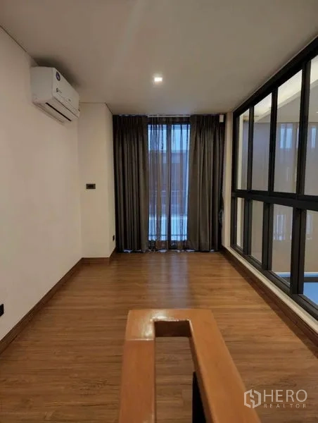 Townhouse for sale in Yan Nawa, Bangkok - Upper hallway or study nook with wood flooring, windows and wall-mounted air conditioner.