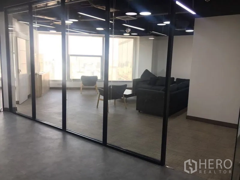 Office Space for rent in Sathon, Bangkok - Glass-walled lounge or reception with sofas and armchairs beside a large bright window.