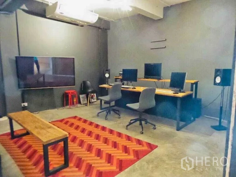 Home Office for rent or sale in Din Daeng, Bangkok - Media or editing room with multiple monitors, wall-mounted TV, speakers and chevron rug.