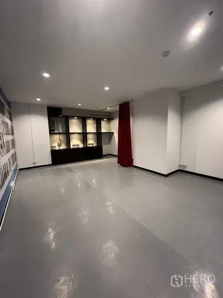 Retail Space for rent in Watthana, Bangkok - Open‑plan retail interior with grey floors, spotlights, and built‑in illuminated display cabinets.