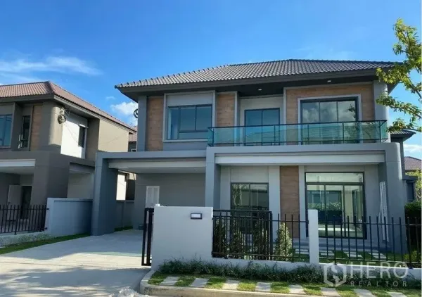 Detached House for rent - Front elevation of two-storey home with covered carport and glass balcony.