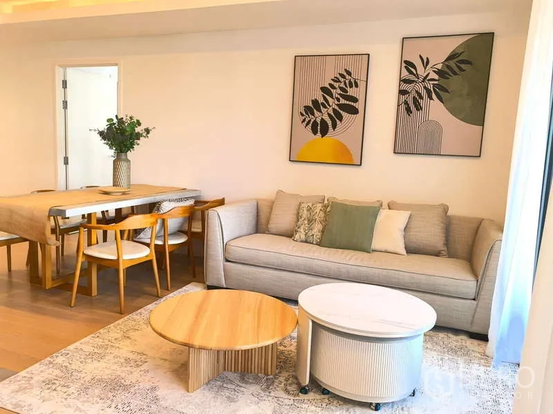 Apartment for rent - Light-filled living and dining area with sofa and framed art on the wall.