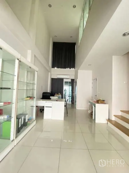 Home Office for rent or sale - Open-plan office space with display cabinets, high ceiling and light from front and rear windows.