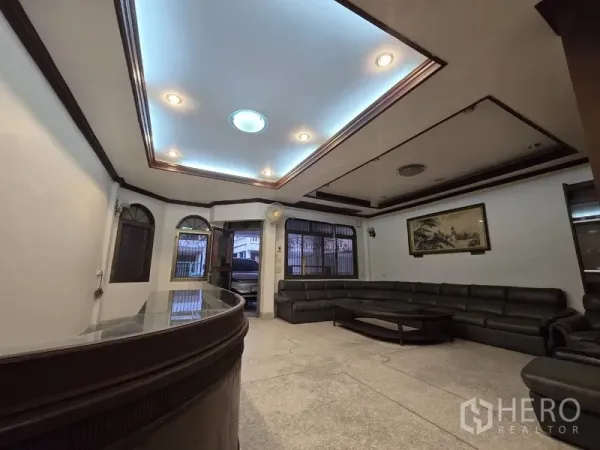 Home Office for rent in Sathon, Bangkok - Reception area from another angle showing a curved counter and recessed lighting.