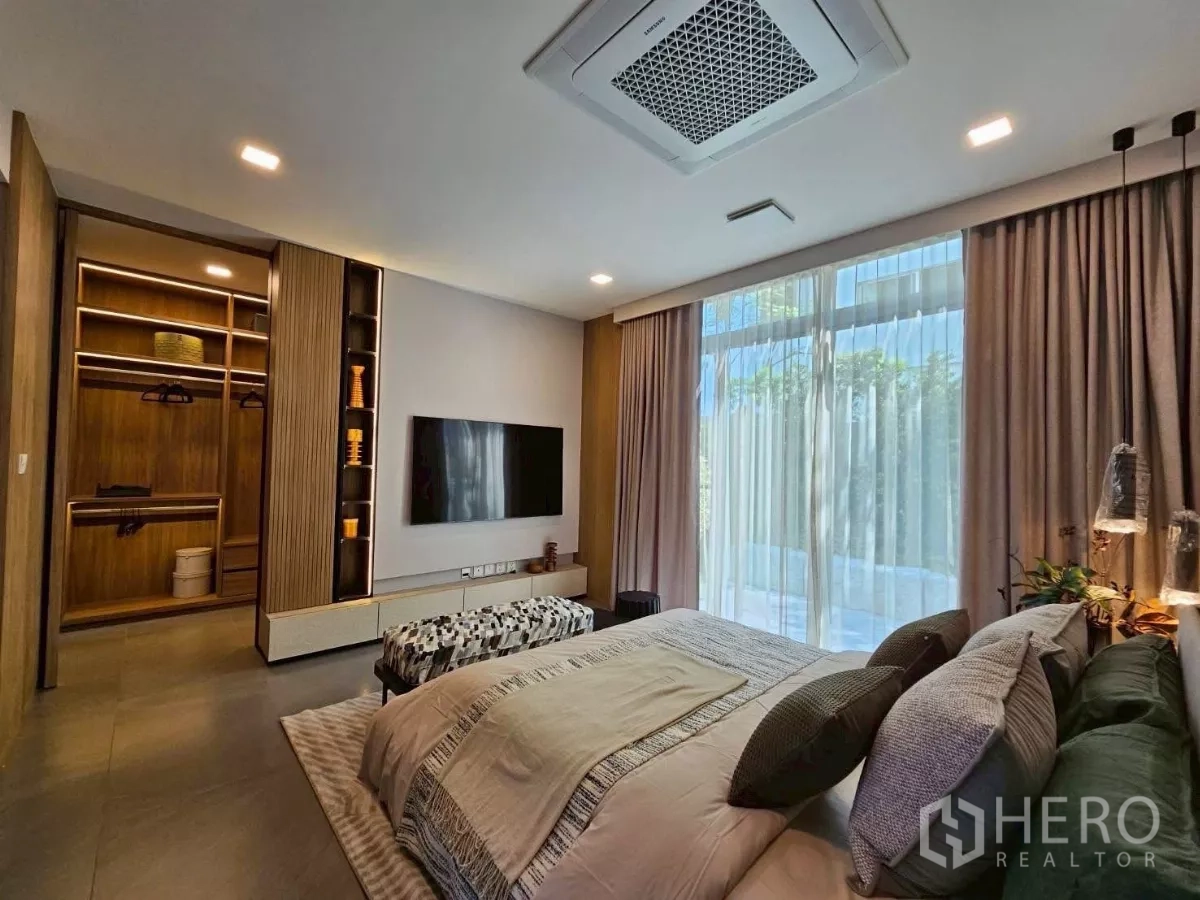 Detached House for rent in Saphan Sung, Bangkok - Primary suite view with TV wall and an illuminated walk-in closet.