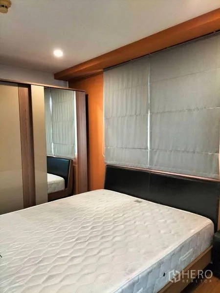 Condominium for rent in Watthana, Bangkok - Bedroom with mirrored wardrobe, blinds and a queen bed frame.