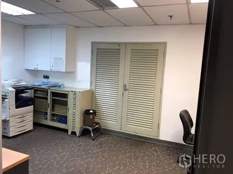 Office Space for rent in Khlong Toei, Bangkok - Utility room with printer, cabinets and louvered storage doors.