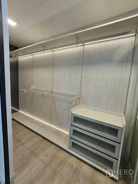 Detached House for rent - Walk‑in closet with LED‑lit hanging rails, drawers and wood floors.