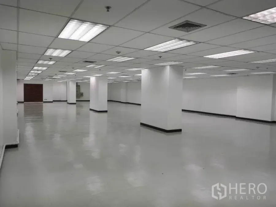 Office Space for rent in Phaya Thai, Bangkok - Empty open workspace with structural columns, vented ceiling and smooth reflective flooring.