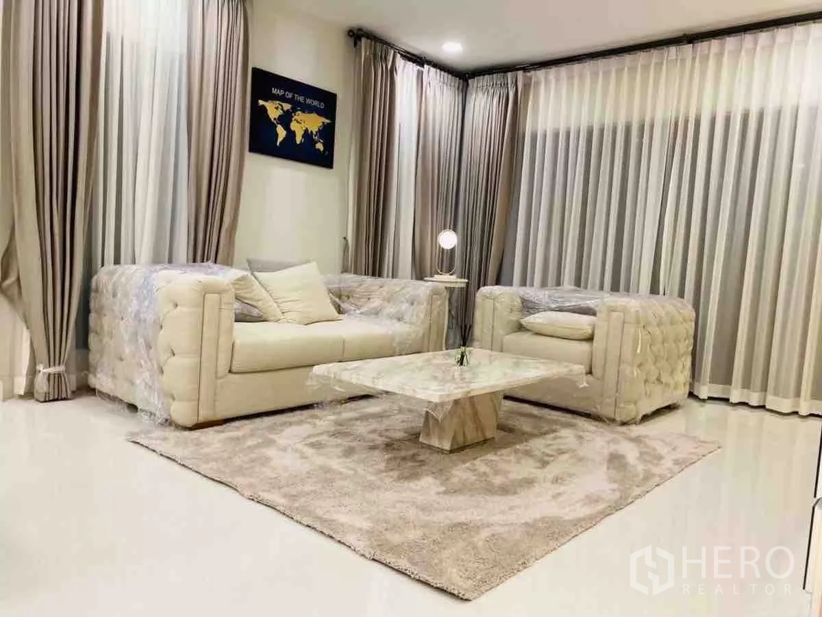 Detached House for rent or sale in Saphan Sung, Bangkok - Second living area view with sheer drapes and marble coffee table on rug