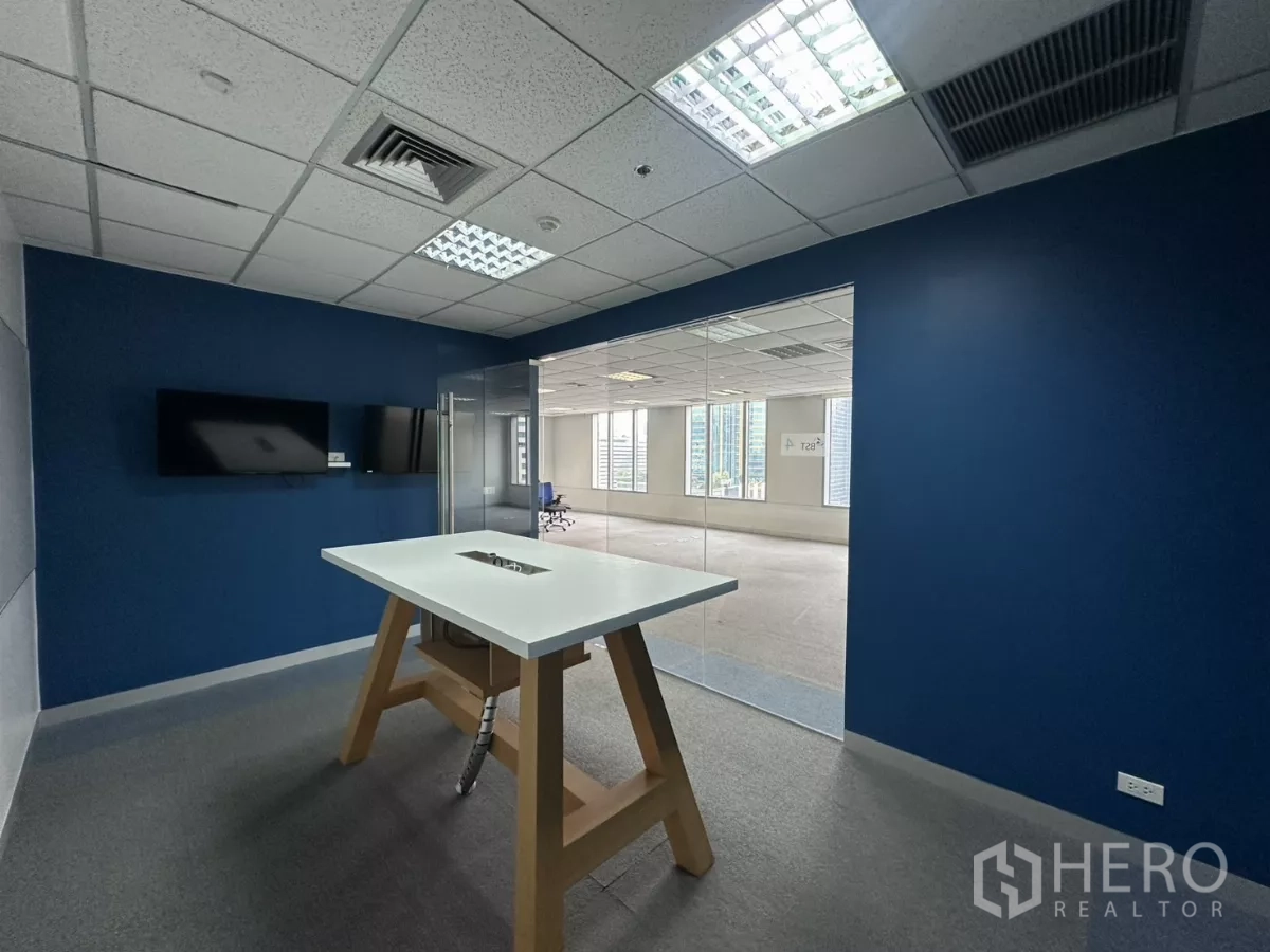 Office Space for rent in Watthana, Bangkok - Glass-enclosed focus room with a high table and wall-mounted monitor.
