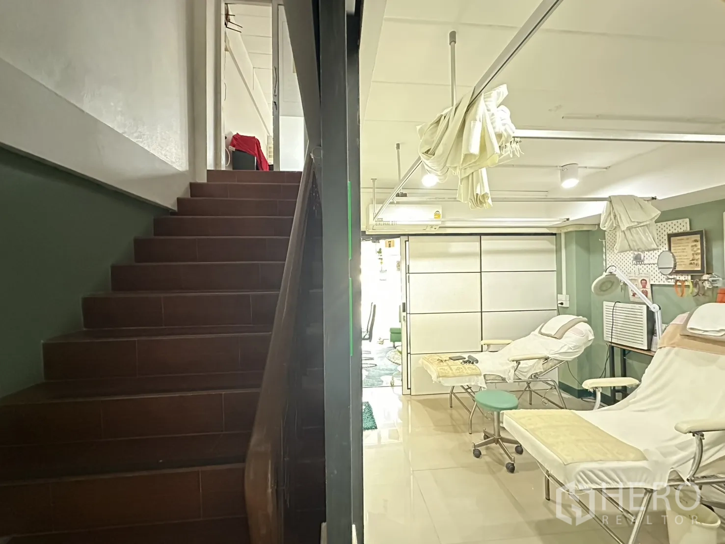 Shophouse for rent in Phra Khanong, Bangkok - Staircase beside the open workspace leading to upper floors.