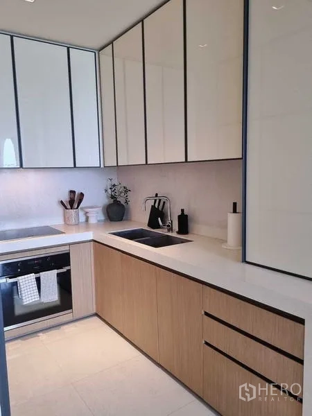 Condominium for sale - Built-in wardrobe area with black-stone vanity and cushioned stool.