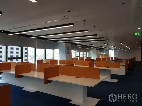 Office Space for rent in Huai Khwang, Bangkok - Spacious desk rows with orange privacy screens under linear LED lights and panoramic windows.