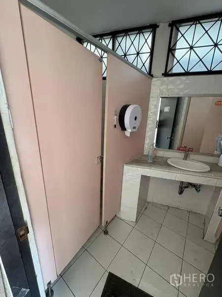 Standalone for rent in Khlong Toei, Bangkok - Restroom area with pink partitions and single sink.