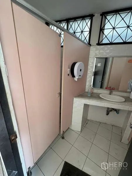 Standalone for rent in Khlong Toei, Bangkok - Restroom area with pink partitions and single sink.