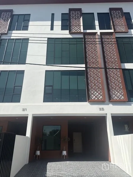 Home Office for rent in Wang Thonglang, Bangkok - Modern townhouse facade with tall windows and decorative lattice panels.