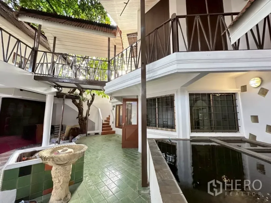 Home Office for rent in Lat Phrao, Bangkok - Courtyard with fish pond, barred windows and wood-and-metal railings