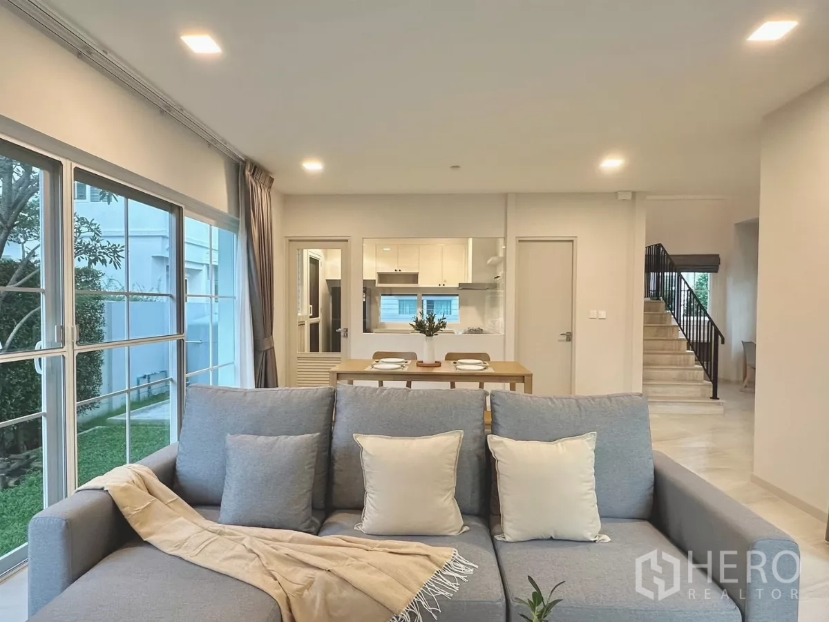Detached House for rent in Bang Phli, Samut Prakan - Living room view toward the kitchen, dining table and staircase with abundant natural light.