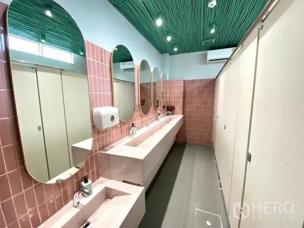 Retail Space for rent in Watthana, Bangkok - Modern shared restroom featuring pink tiles, long vanity with mirrors and a green acoustic ceiling.