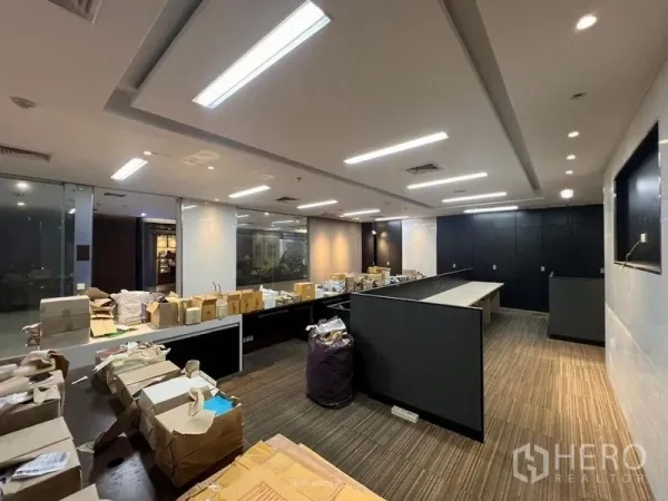 Retail Space for rent - Wide shot of the main sales floor with long counters, glass walls and ceiling lights, ready for fit-out.
