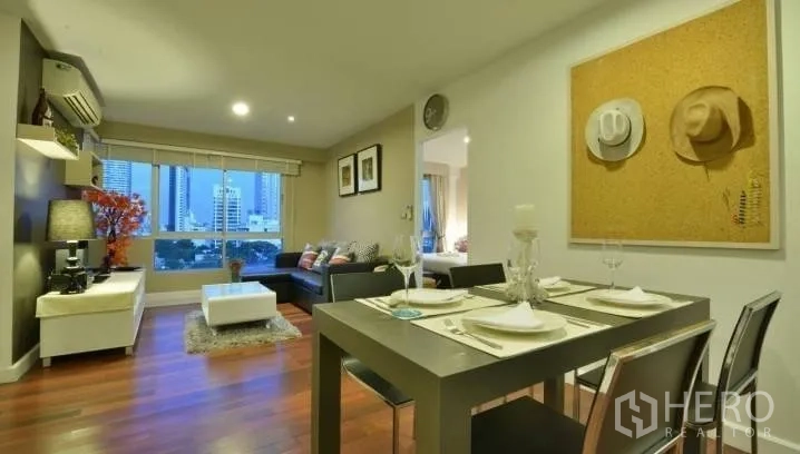 Condominium for rent in Watthana, Bangkok - Open-plan living and dining area with wood floors, skyline view window, sofa and a set table for four.