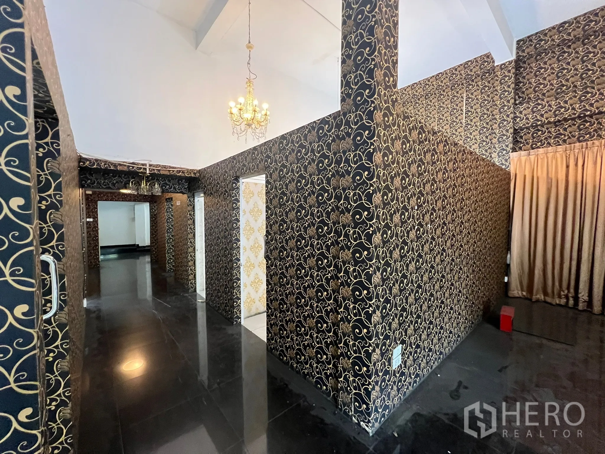 Shophouse for rent in Khlong Toei, Bangkok - Partitioned hallway with patterned walls, doorway to a white-gold room and drapes.