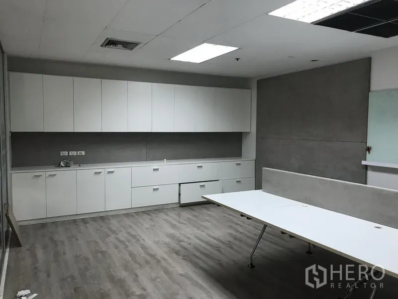 Retail Space for rent in Pathum Wan, Bangkok - Open office area featuring long built-in white cabinets, worktable and LED lighting.
