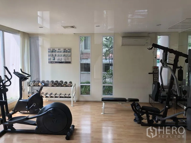 Detached House for sale in Wang Thonglang, Bangkok - Residents’ fitness room equipped with cardio machines, free weights, and mirrors.